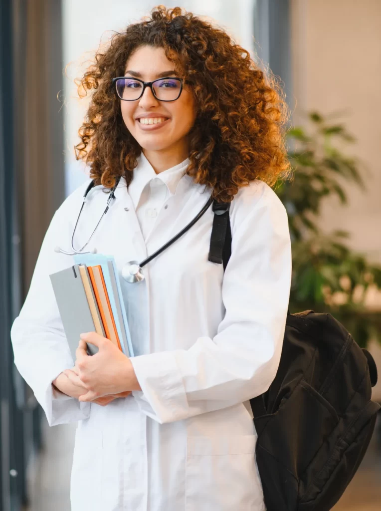 smiling young woman with lab coat and stethoscope utc
